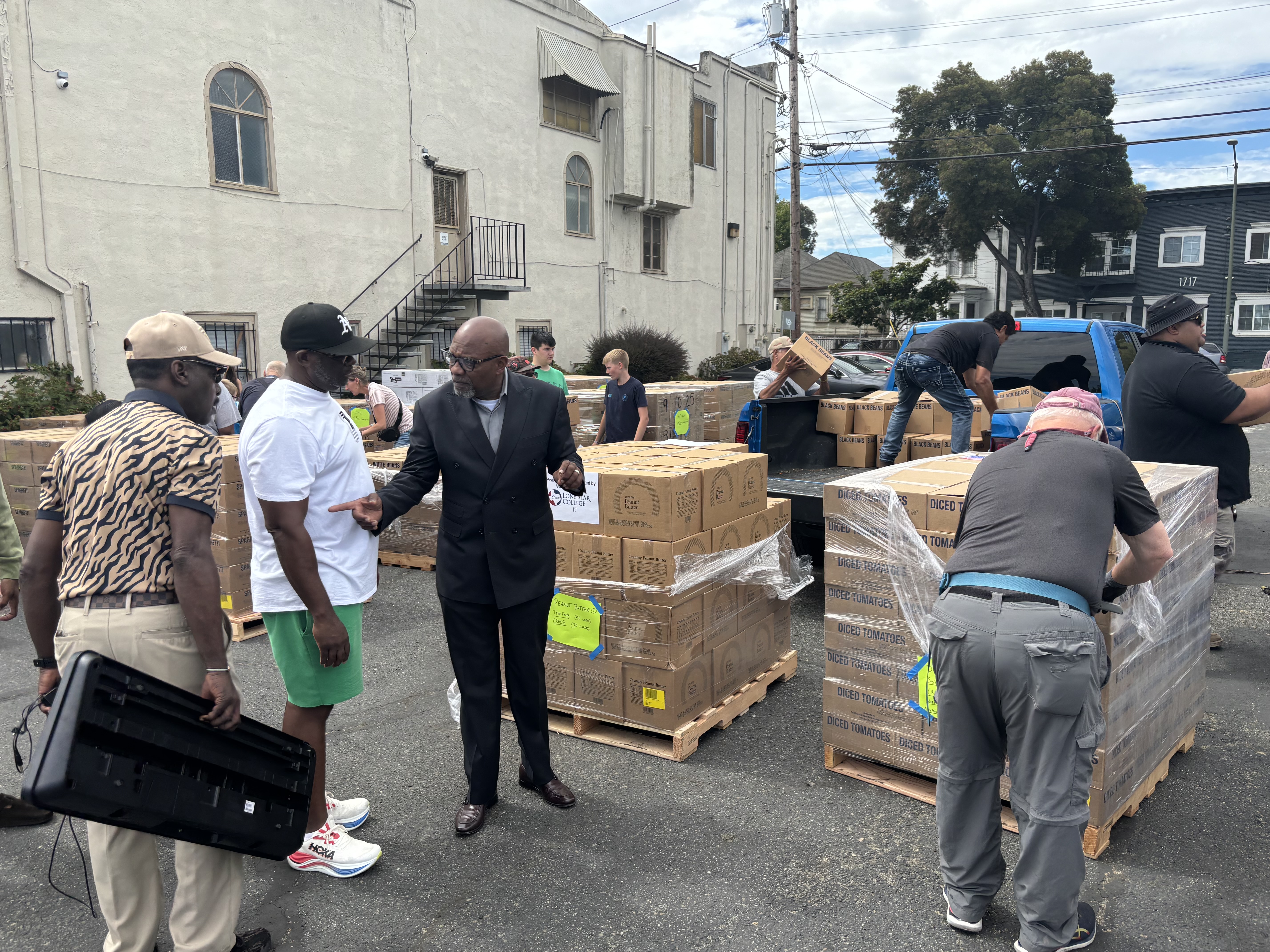 Pastor Michael Wallace of Mt. Zion Missionary Baptist Church provides instruction as volunteers unpack pallets of food to be distributed. “We believe that having food is a basic human right and to address it is our Christian duty,” Wallace said. “That’s what makes this partnership so meaningful.” Courtesy photo.